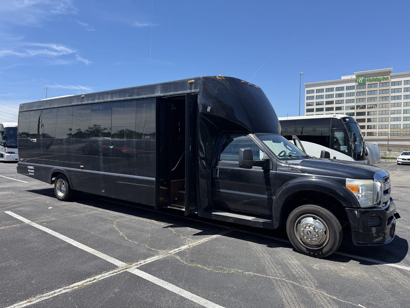 Party Bus R Us black party bus exterior in daylight