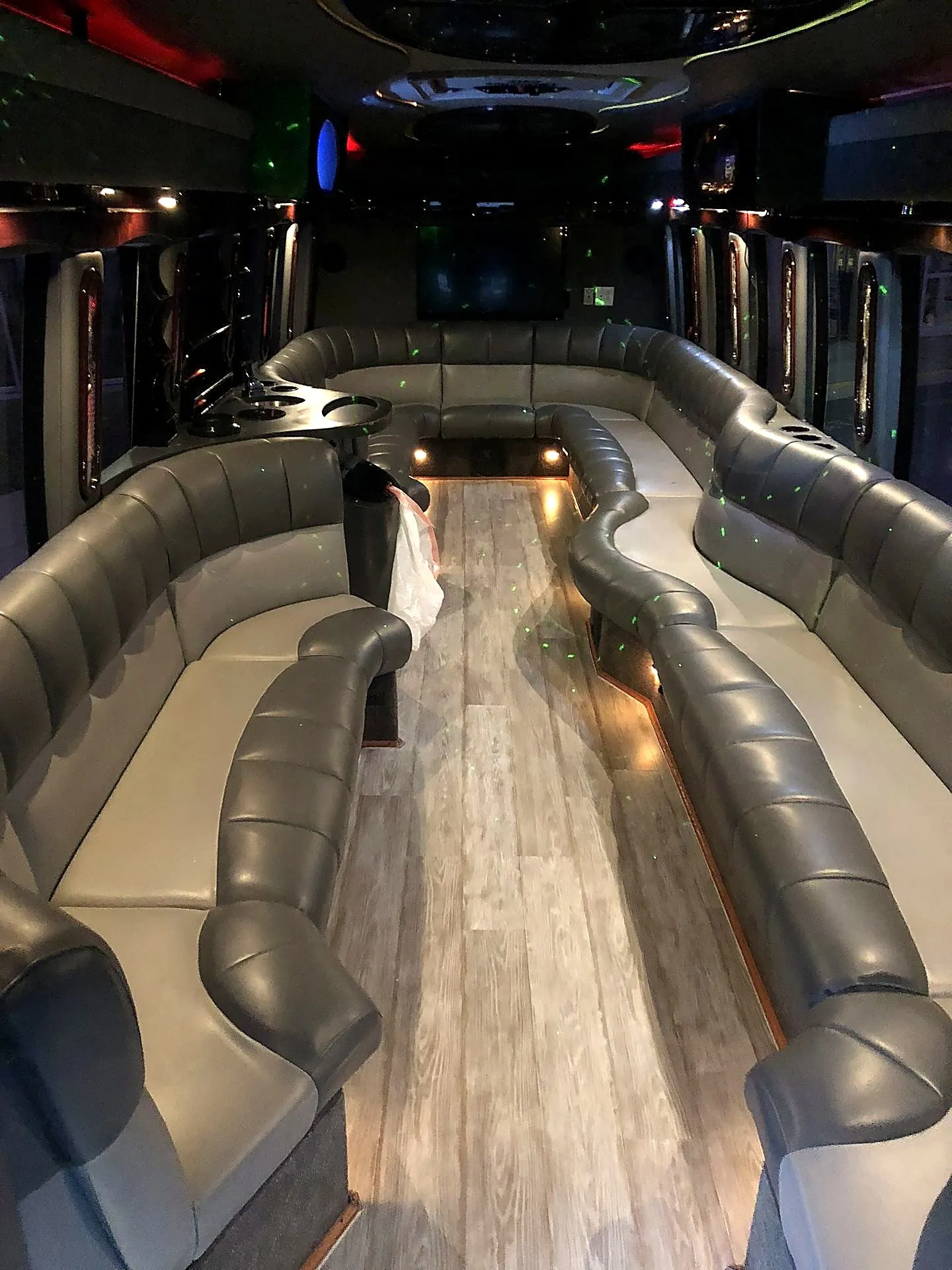 Bus interior with two-tone grey seating and wood flooring