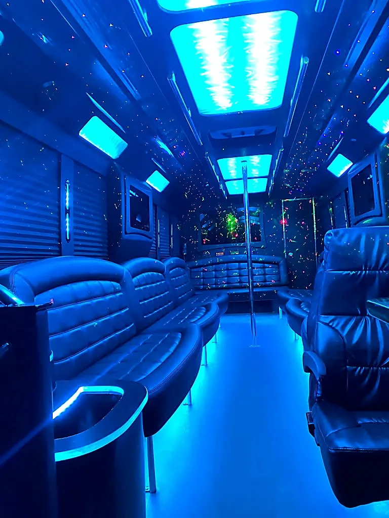 Blue LED interior of party bus with dance pole