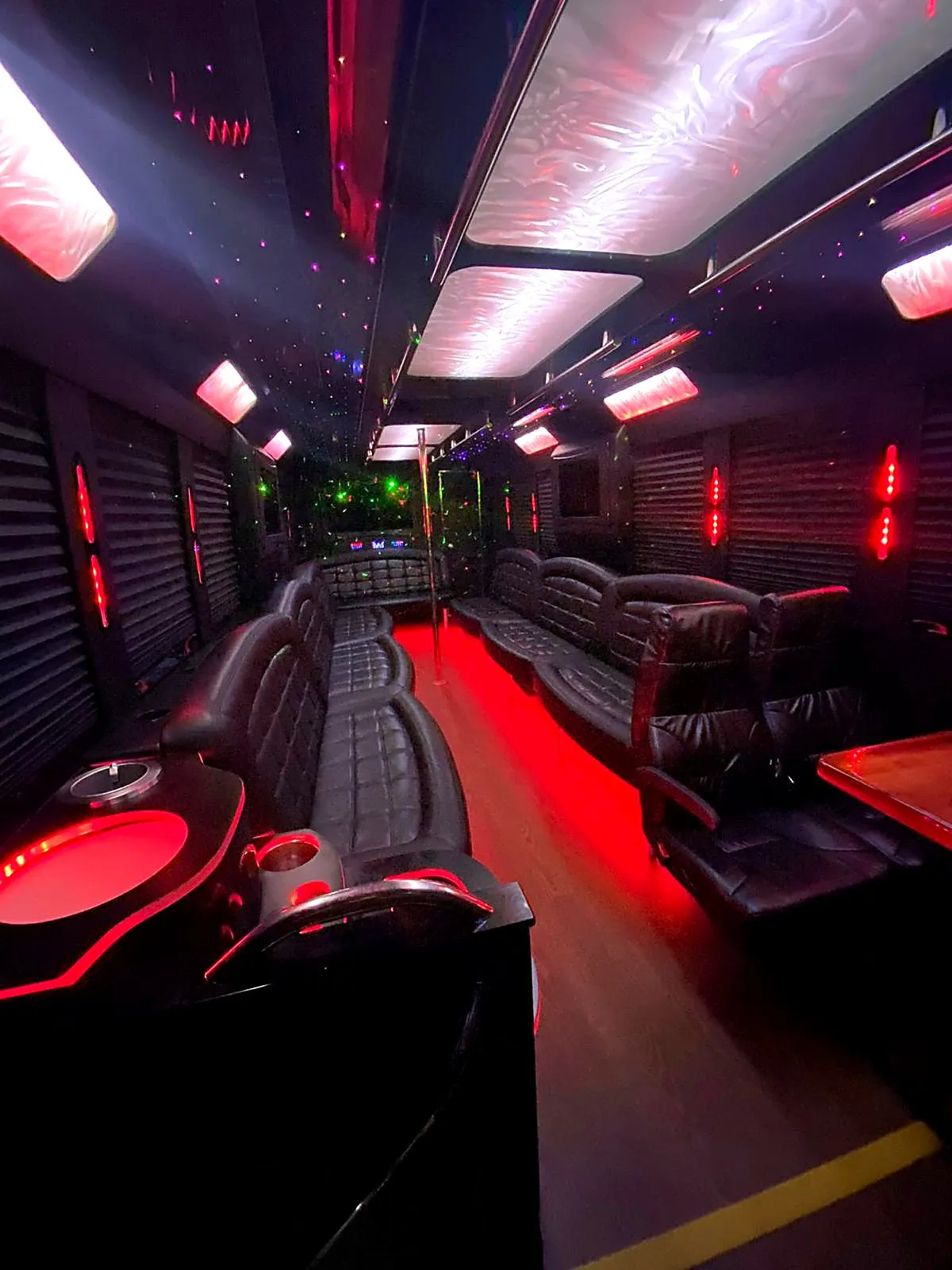 Bus seating and aisle illuminated by red lighting
